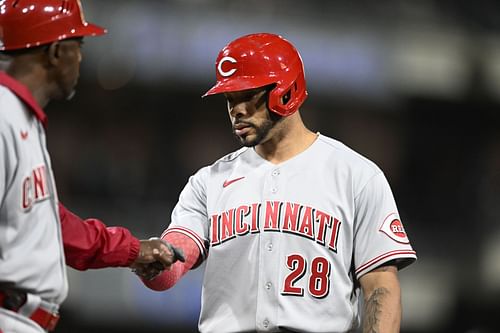 Cincinnati Reds 1B coach congratulates Tommy Pham for base hit against the San Diego Padres.