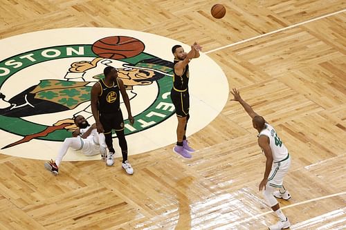 Steph Curry of the Golden State Warriors shoots a three after a screen by teammate Draymond Green.