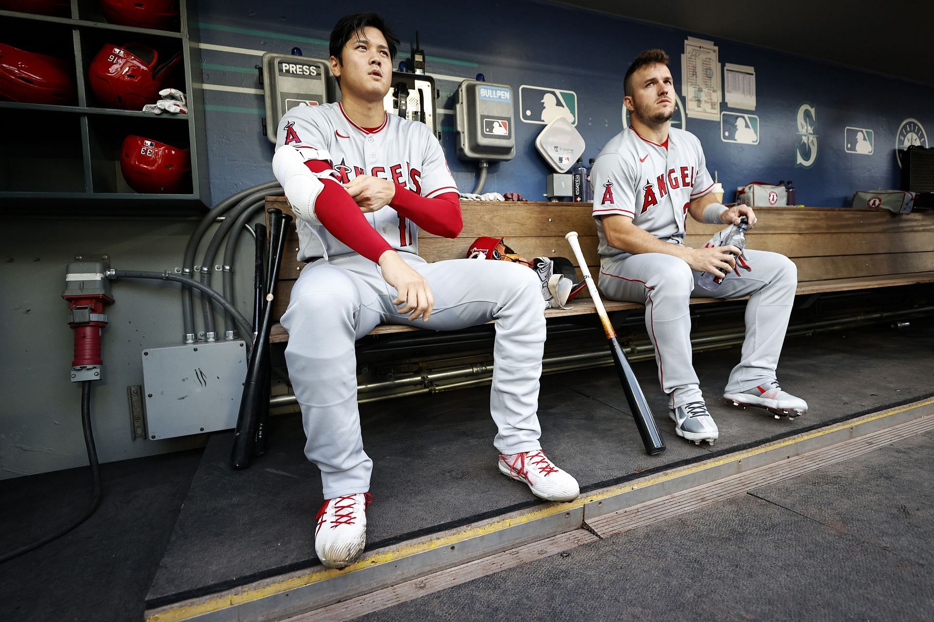 Trout and Ohtani sit together in the dugout during a Los Angeles Angels v Seattle Mariners game.