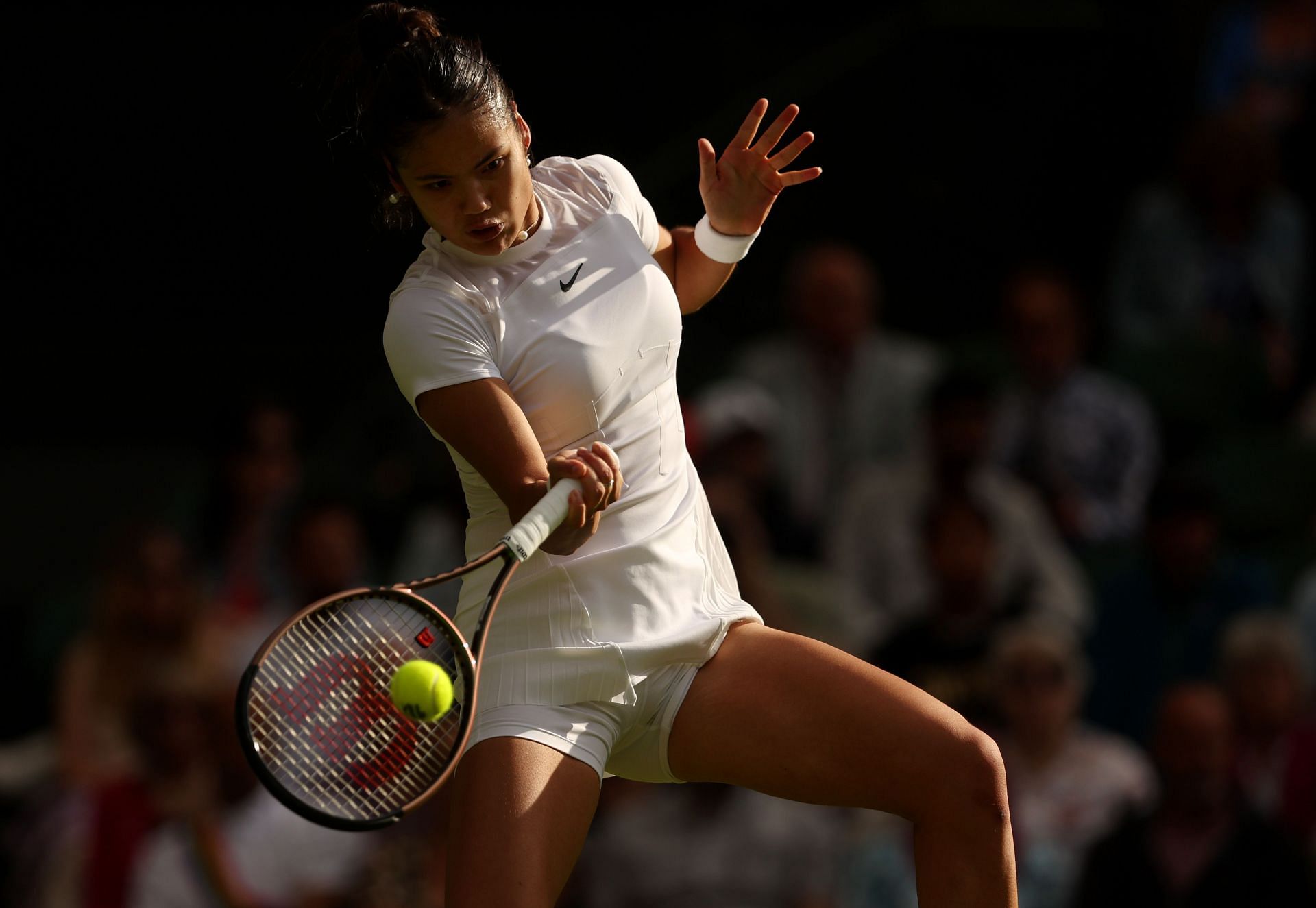 Emma Raducanu plays a forehand in her first-round match at Wimbledon