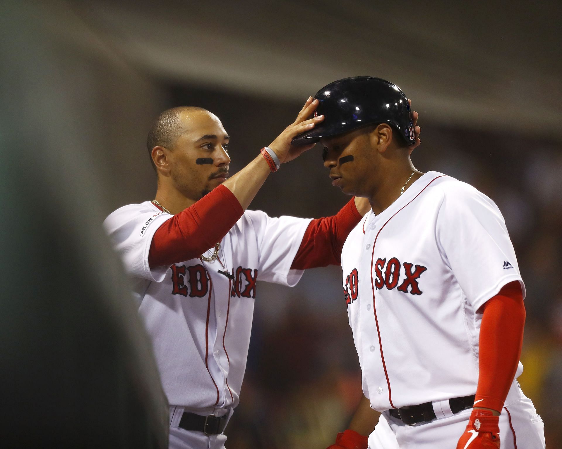 Mookie Betts (left) and Rafael Devers (right) played together on the 2018 Boston Red Sox team that won it all by defeating the Los Angeles Dodgers.