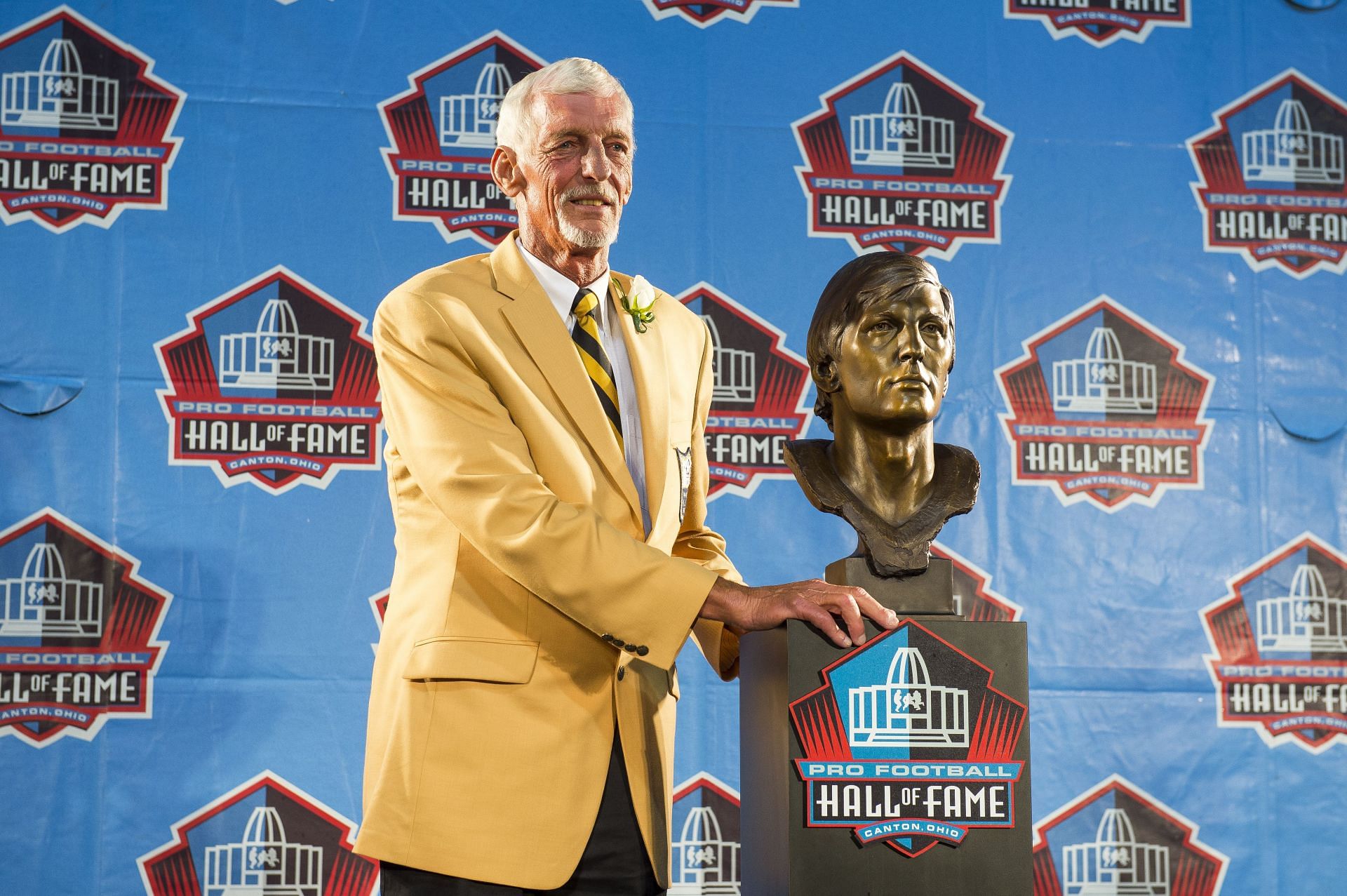 Punter Ray Guy with his bust at the Hall of Fame