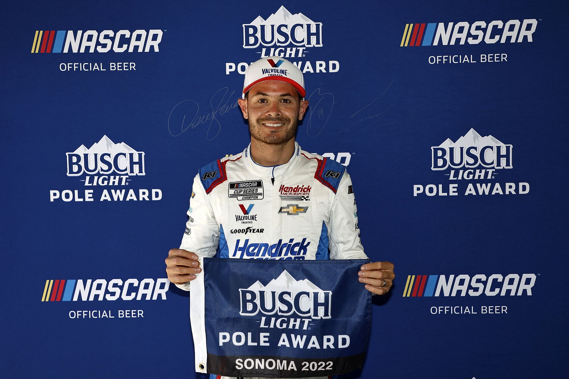 Larson poses for photos after winning the pole award during qualifying for the NASCAR Cup Series Toyota/Save Mart 350 at Sonoma Raceway