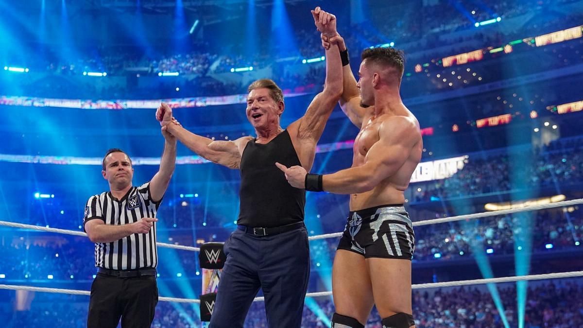 Theory and Vince McMahon celebrating victory at WrestleMania 38