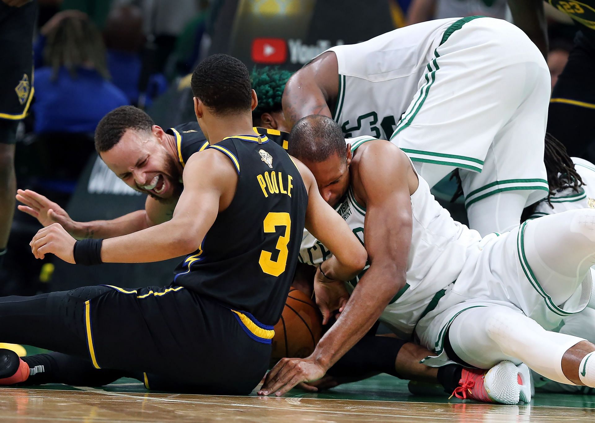 Steph Curry yelling in pain as Al Horford inadvertently sat on his ankle in Game 3 of the NBA Finals. [Photo: The Boston Globe]