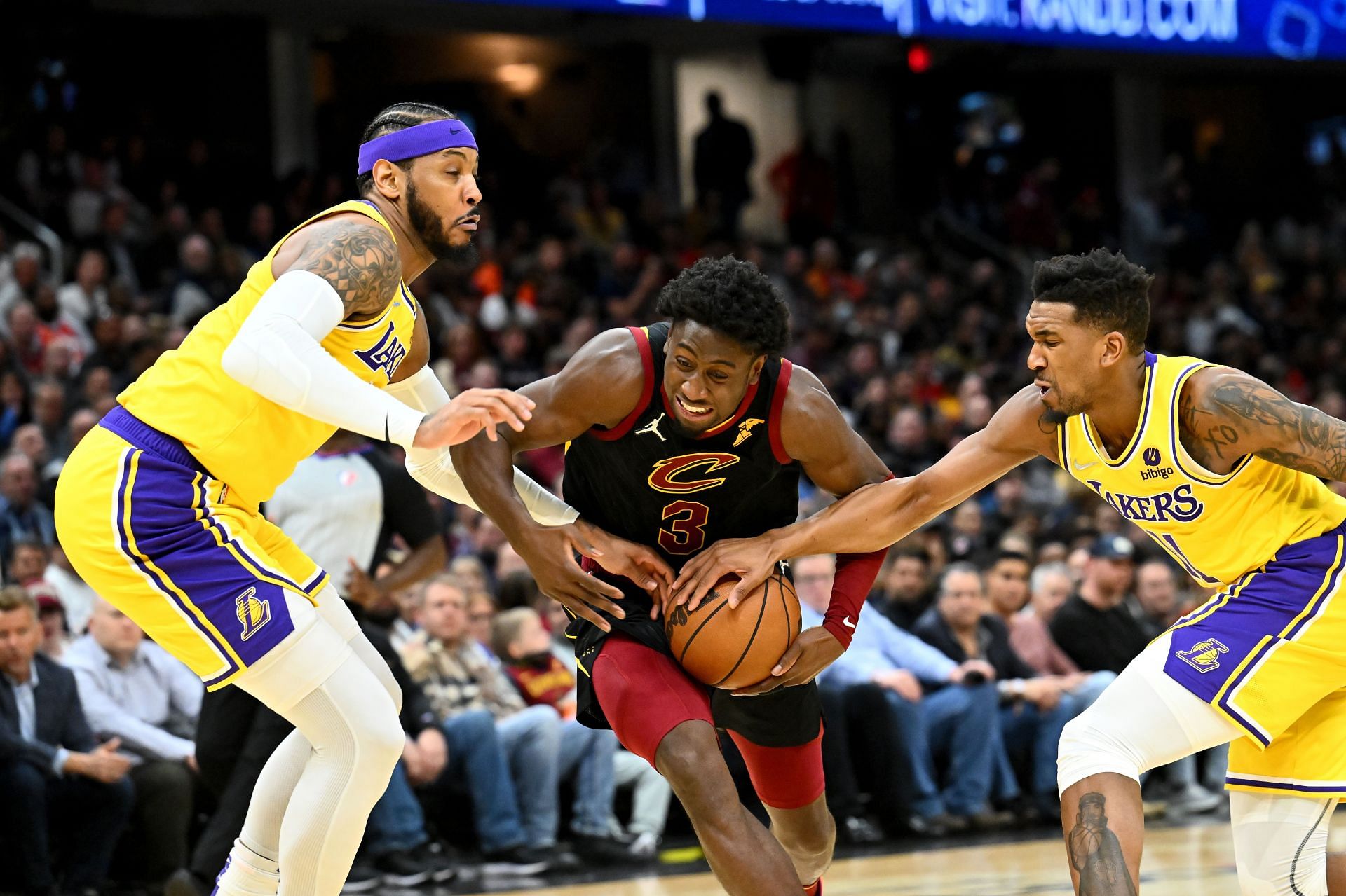 Carmelo Anthony (left) and Malik Monk (right) of the LA Lakers try to dispossess Caris LeVert of the Cleveland Cavaliers