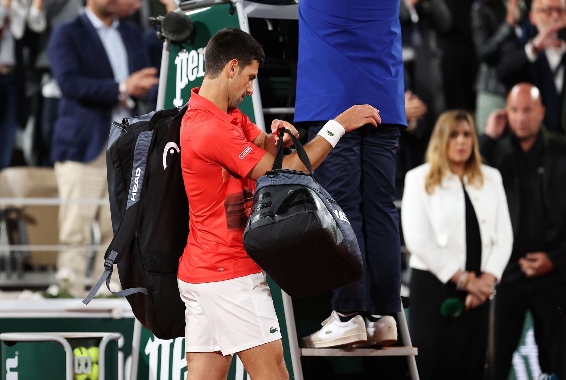 Novak Djokovic walks off the court after his loss to Rafael Nadal at the French Open
