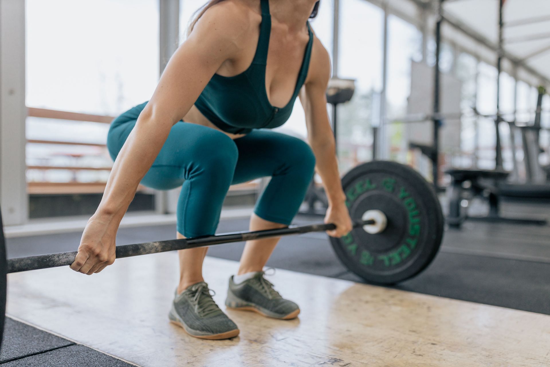 Barbell front squat helps in strengthening your lower body. (Image via Pexels / Anastasia Shuraeva)