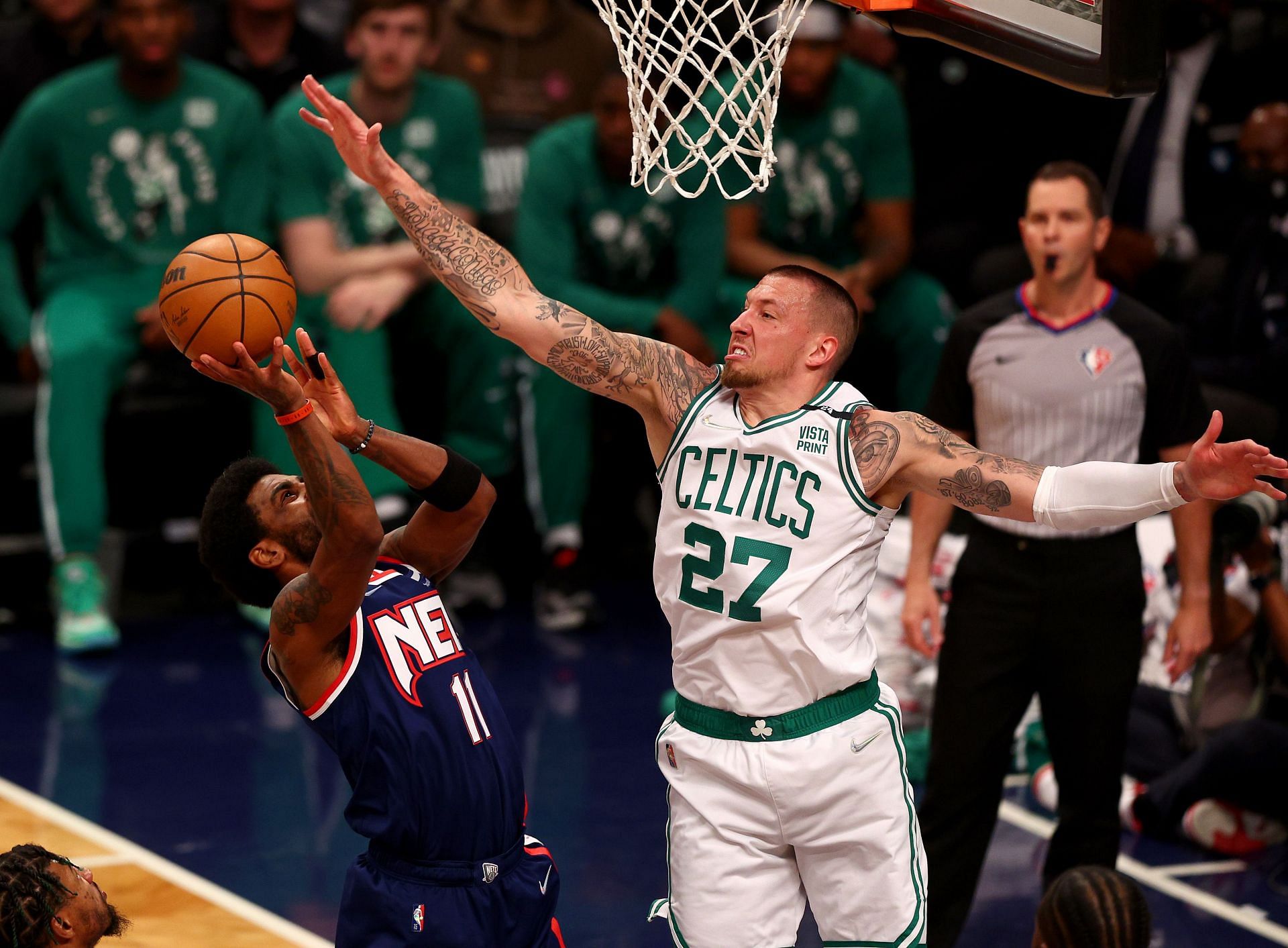 Kyrie Irving of the Brooklyn Nets heads for the net as Daniel Theis of the Boston Celtics defends.