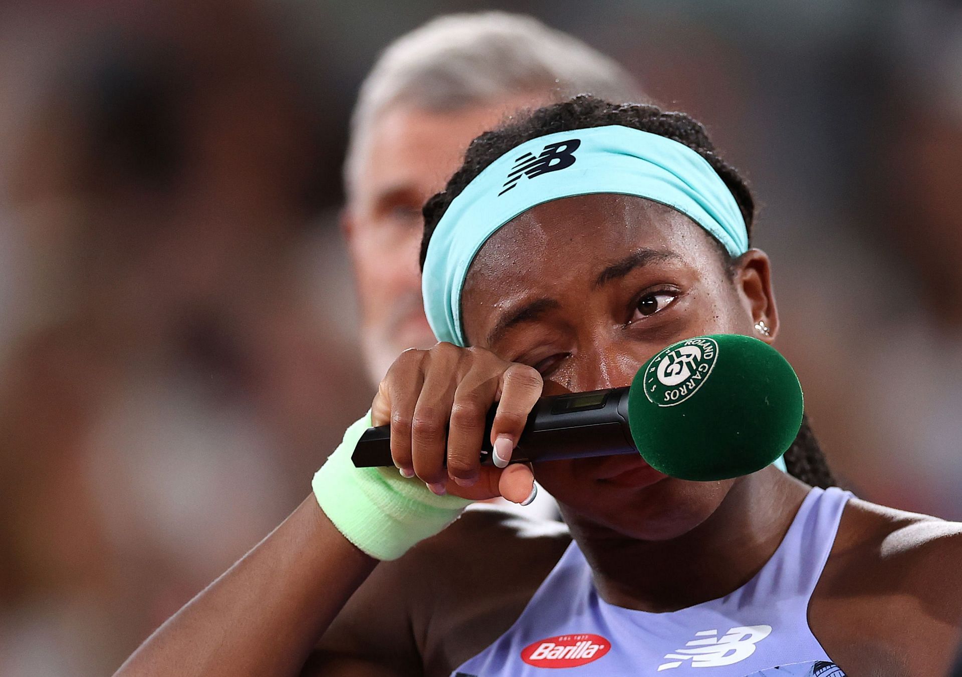 Coco Gauff wipes her tears during her runner-up speech