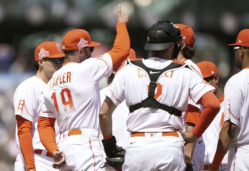 Manager Gabe Kapler of the San Francisco Giants signals the bullpen.