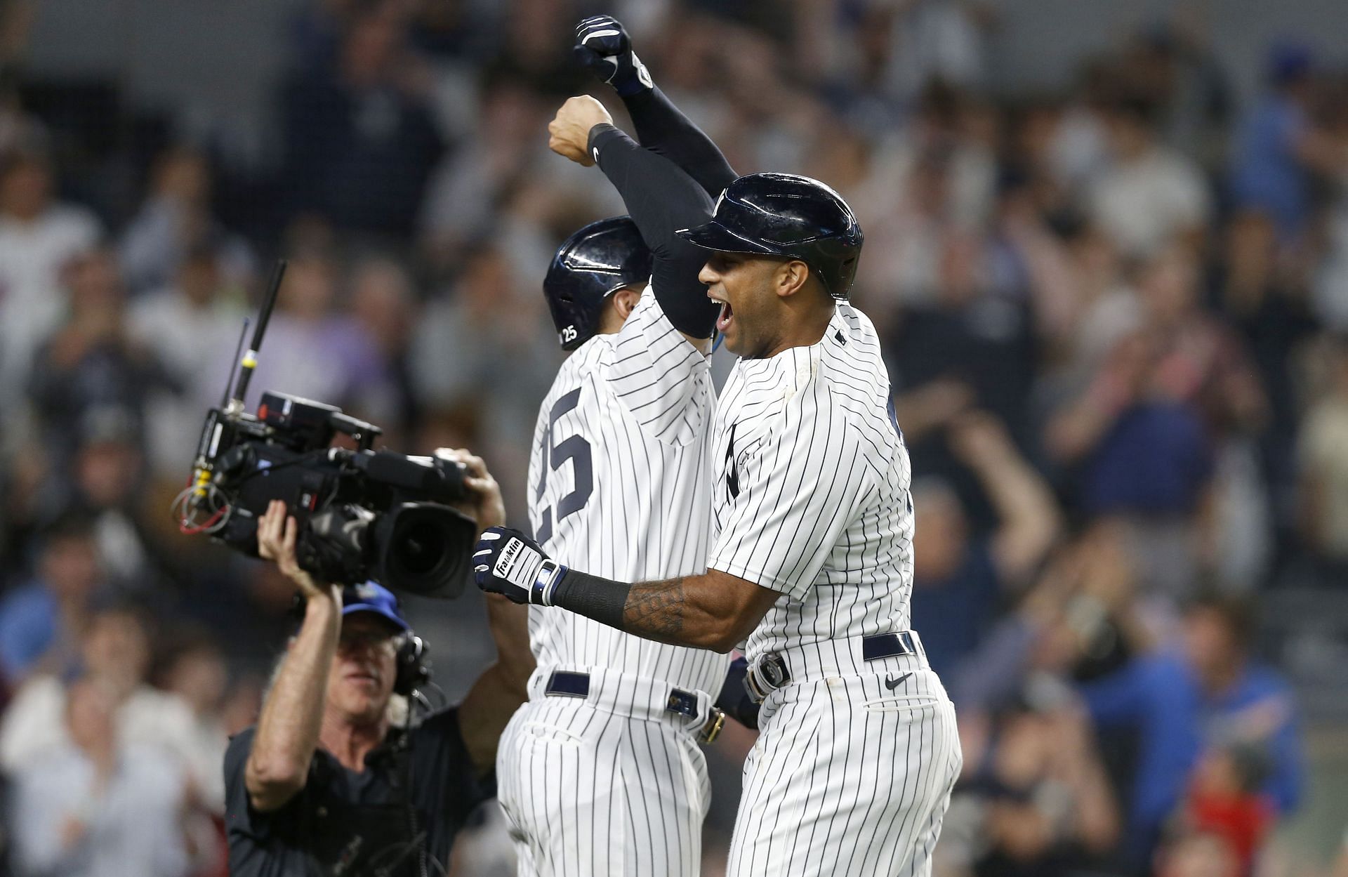 Aaron Hicks of the New York Yankees celebrates his ninth inning game-tying three-run home run against the Houston Astros.