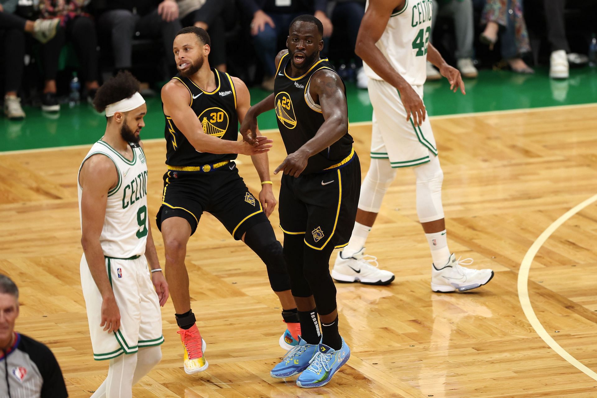 Steph Curry and Draymond Green of the Golden State Warriors react to a play.