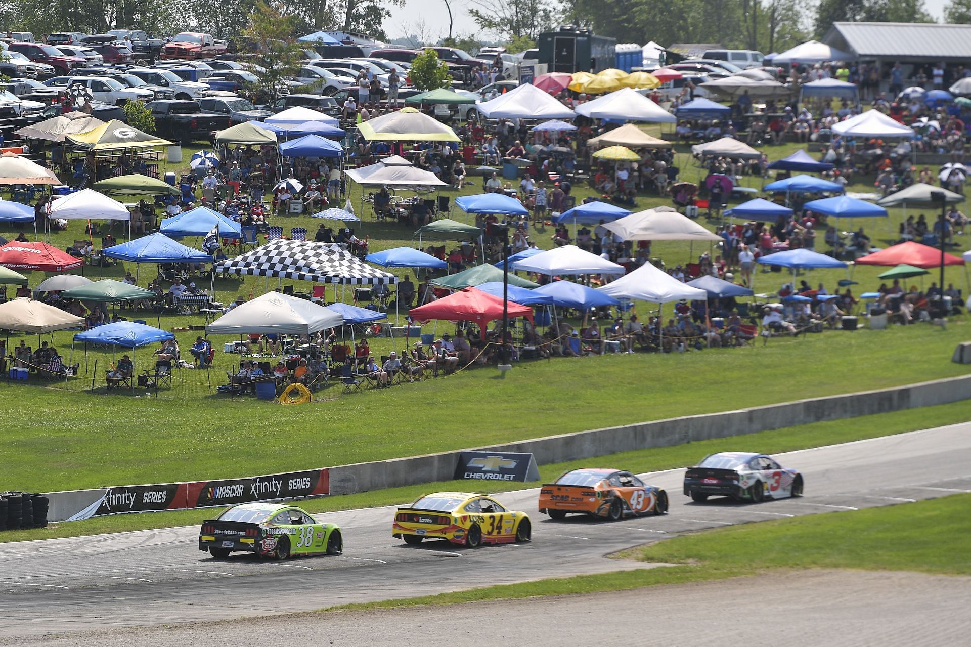 A general view of NASCAR fans on a grassy field and under canopies watching the NASCAR Cup Series Jockey Made in America 250 Presented by Kwik Trip at Road America (Photo by Logan Riely/Getty Images)