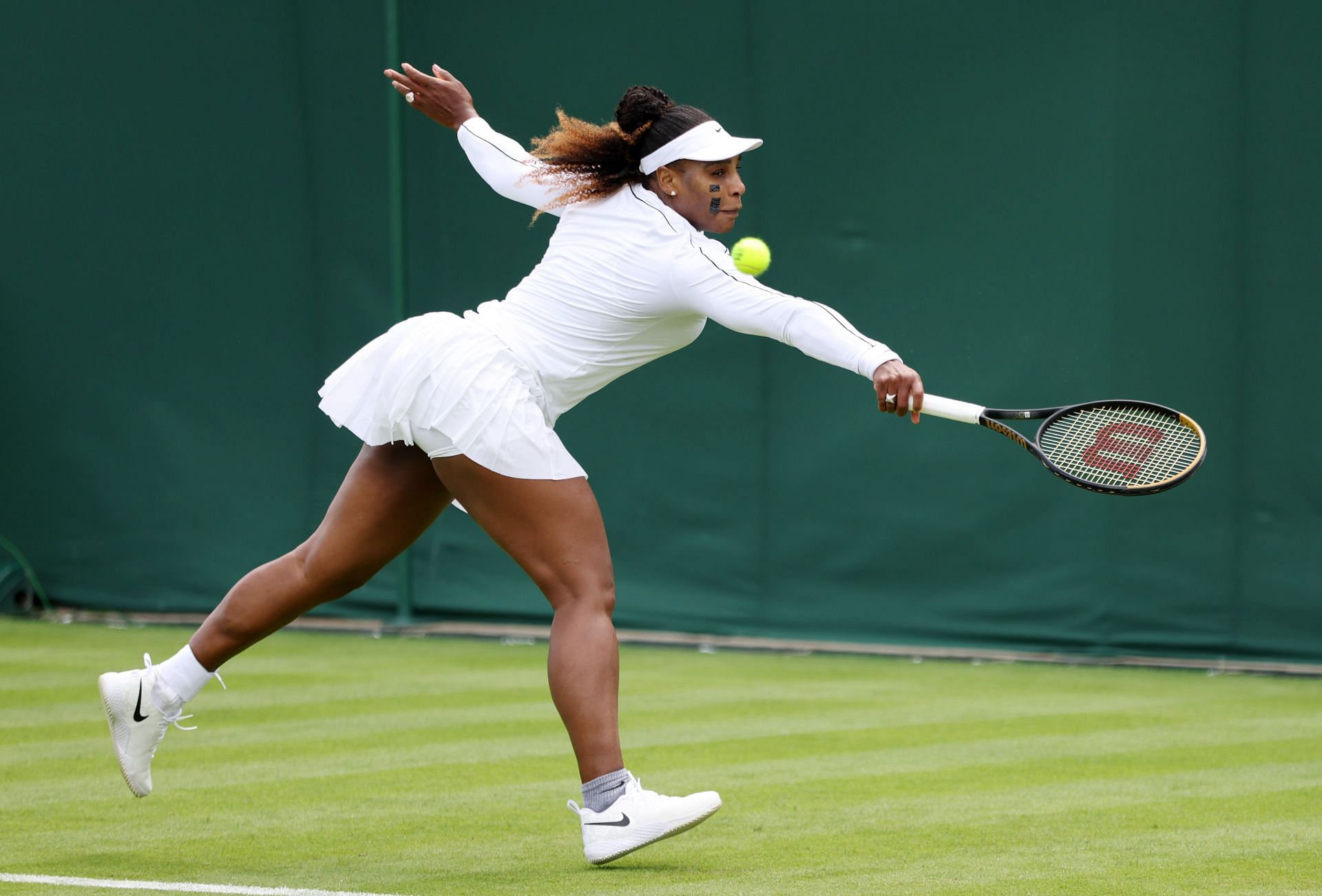 Serena Williams stretches to reach a ball