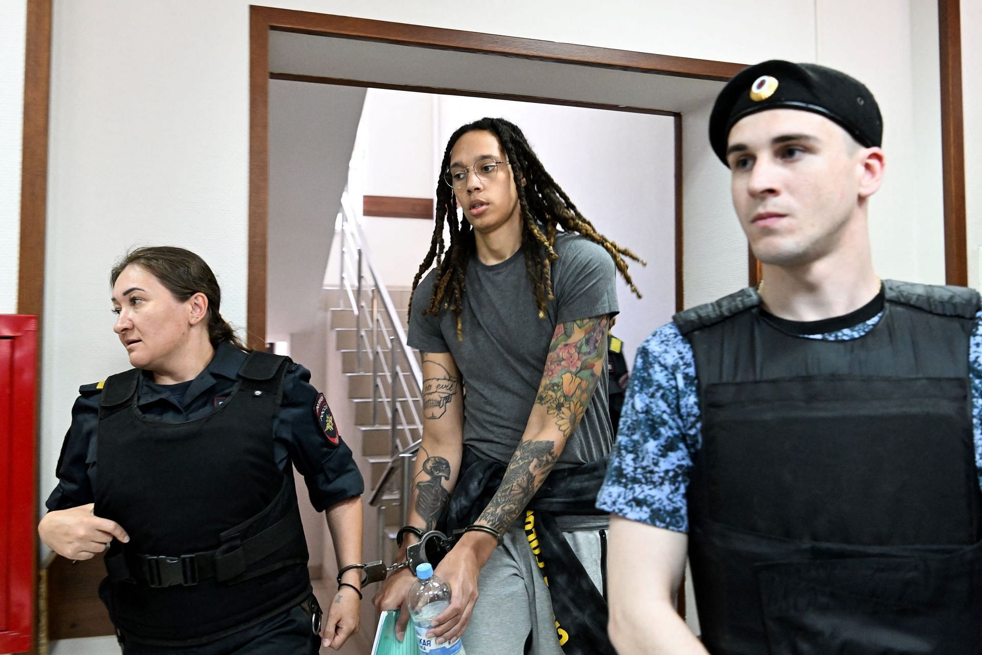 Brittney Griner in shackles being escorted after the court hearing in Russia (Image via Kirill Kudryavstev/AFP/Getty Images)