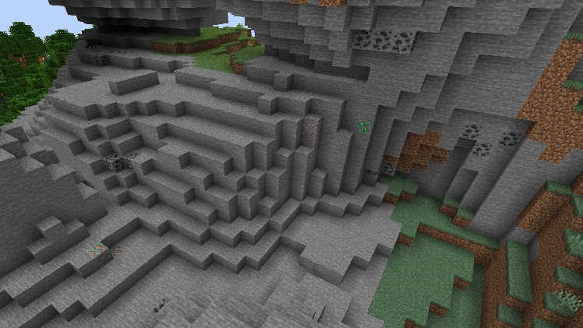 A gravelly Windswept Hill complete with visible ores (Image via Mojang)