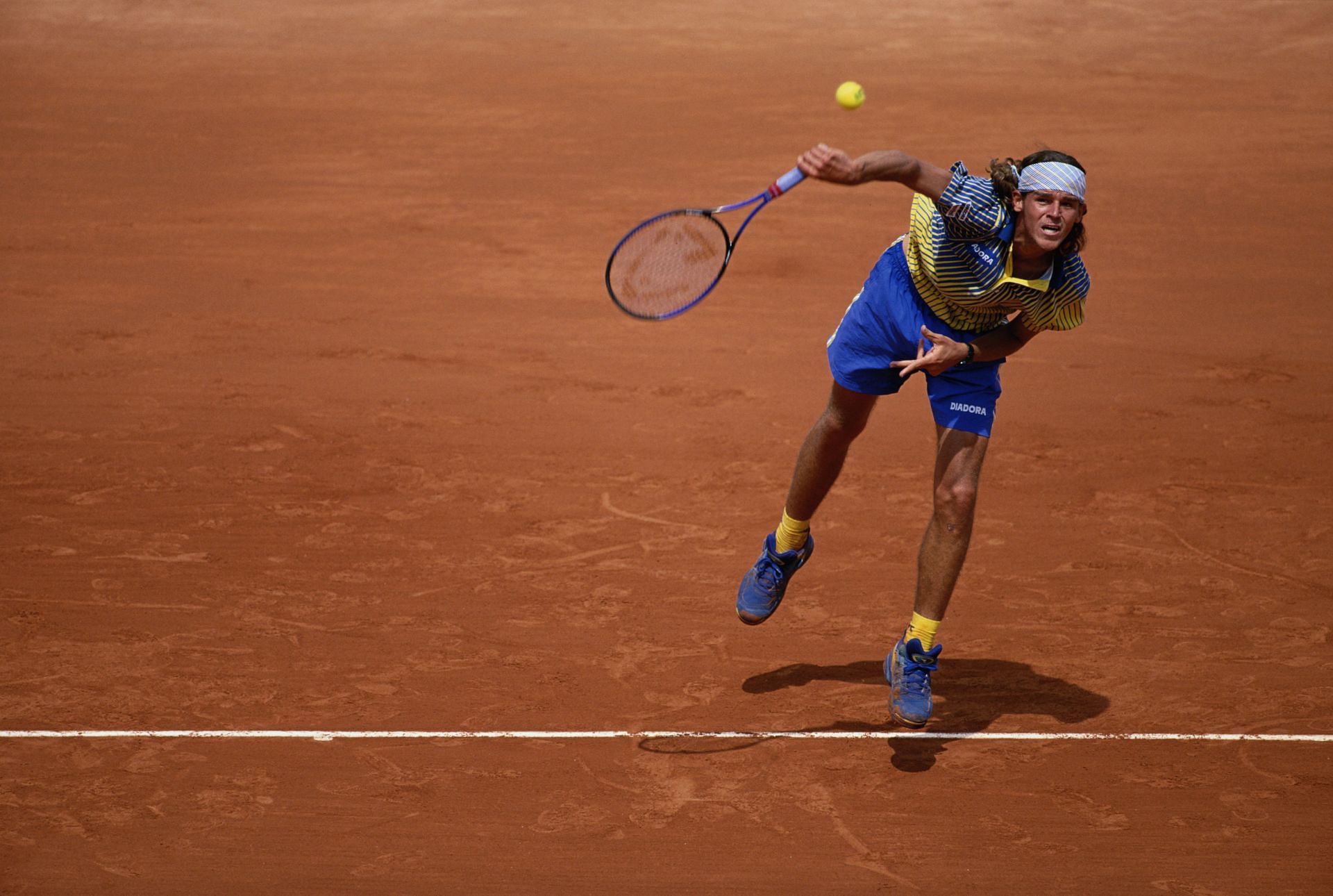 Gustavo Kuerten serves during a match