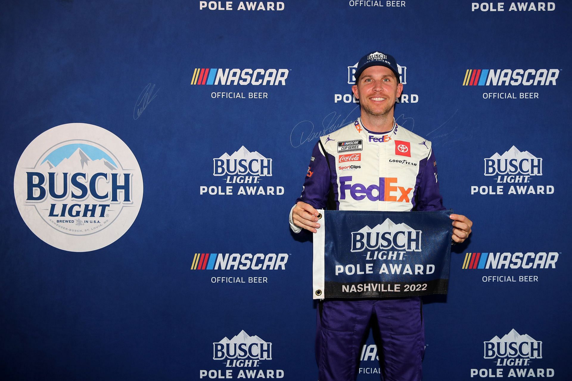 Denny Hamlin poses for photos after winning the pole award during qualifying for the NASCAR Cup Series Ally 400 at Nashville Superspeedway (Photo by Meg Oliphant/Getty Images)