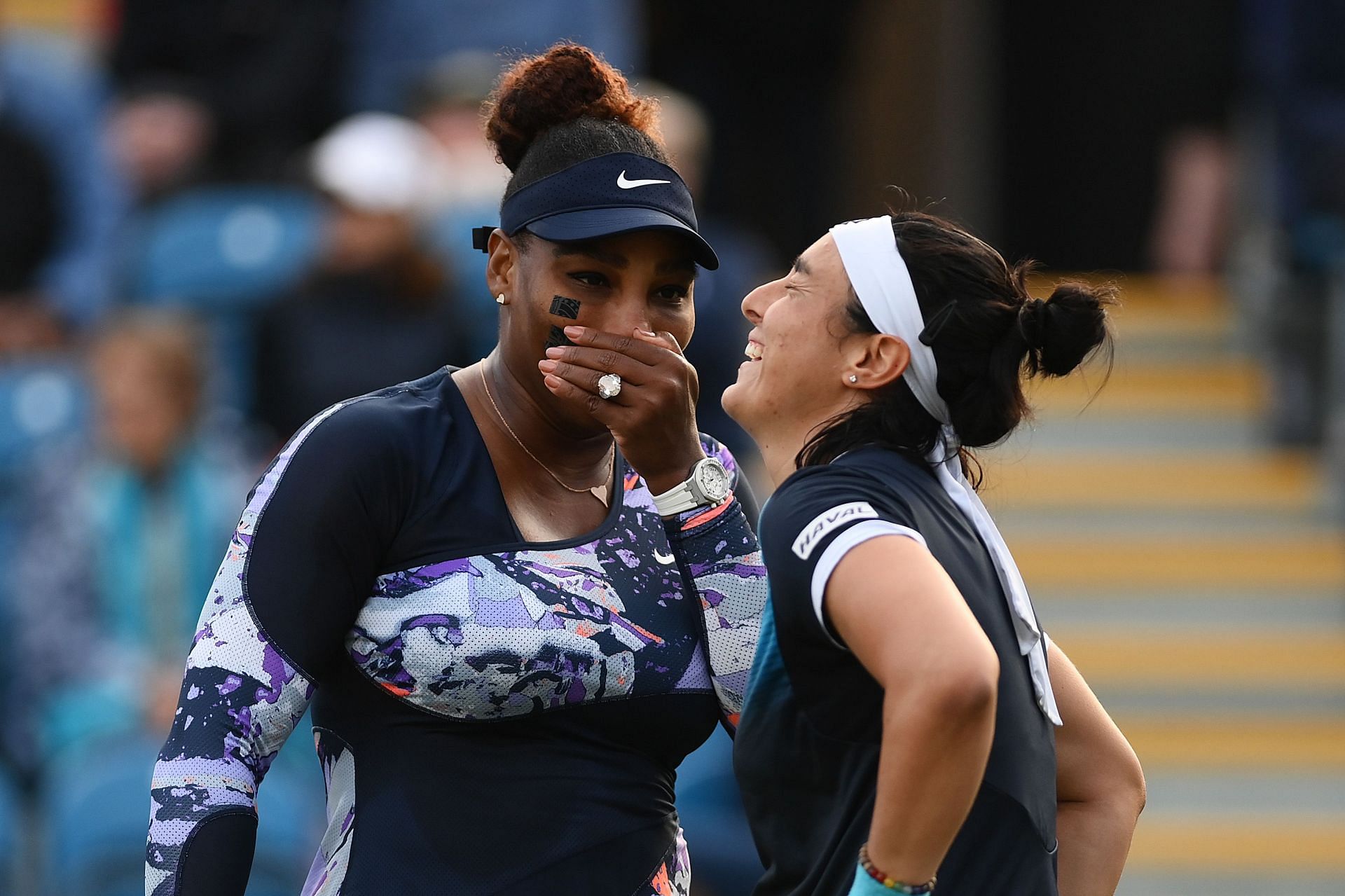 Williams and Jabeur share a light moment during the match
