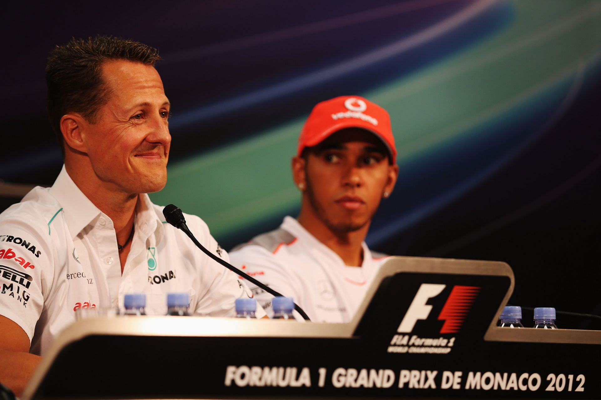 Michael Schumacher (foreground) and Lewis Hamilton (background) ahead of the 2012 Monaco GP (Photo by Clive Mason/Getty Images)
