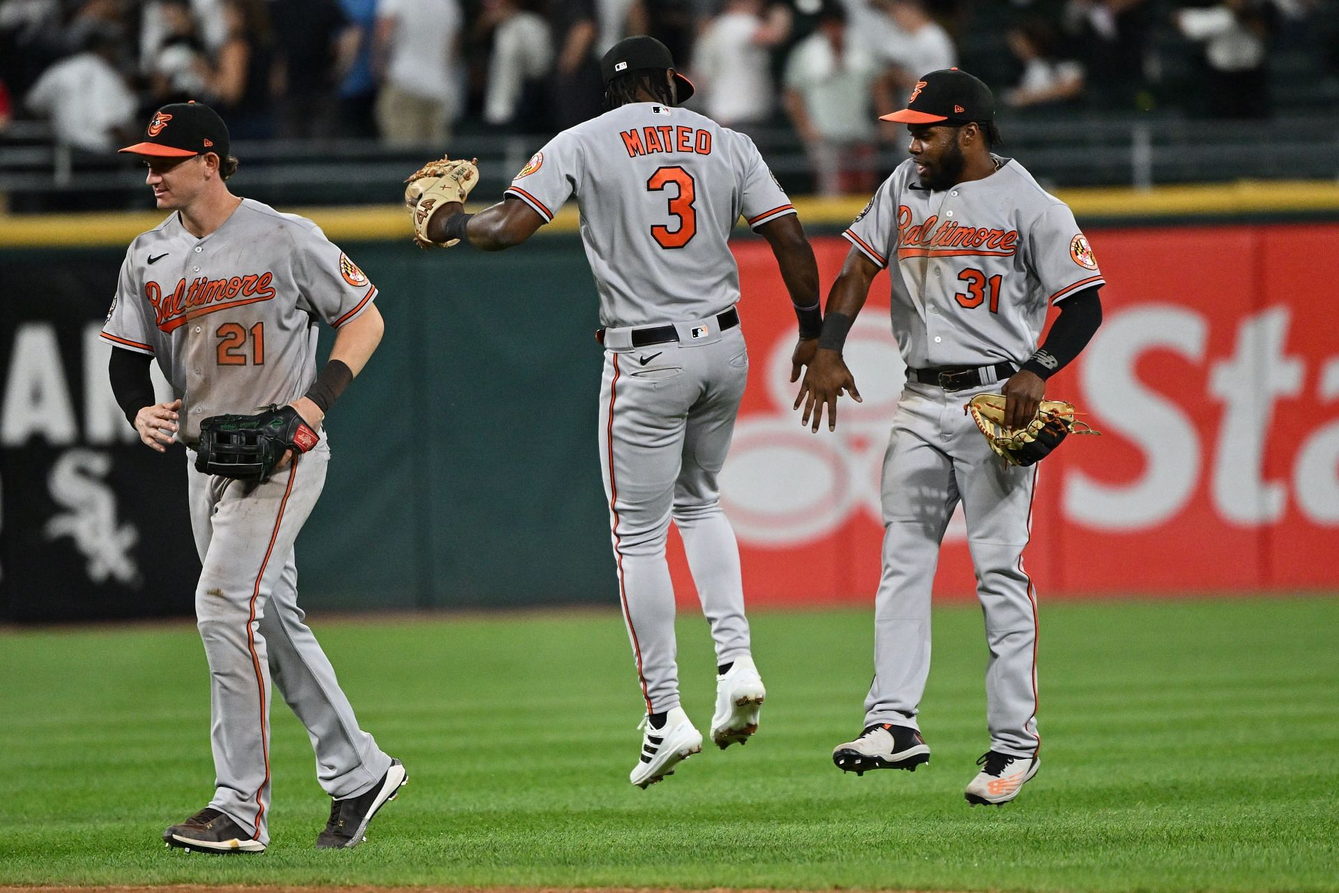 Austin Hays, Jorge Mateo, and Cedric Mullins celebrate after defeating the Chicago White Sox 4-0.