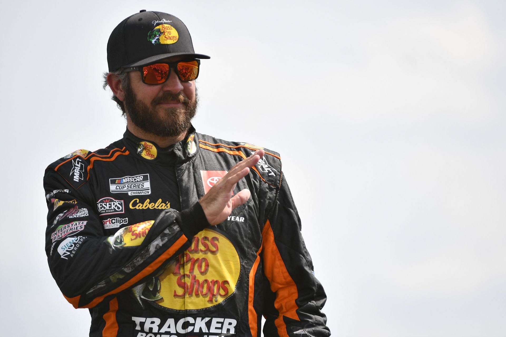 Martin Truex Jr. waves to fans onstage during driver intros before the 2022 NASCAR Cup Series Ally 400 at Nashville Superspeedway in Lebanon, Tennessee (Photo by Logan Riely/Getty Images)