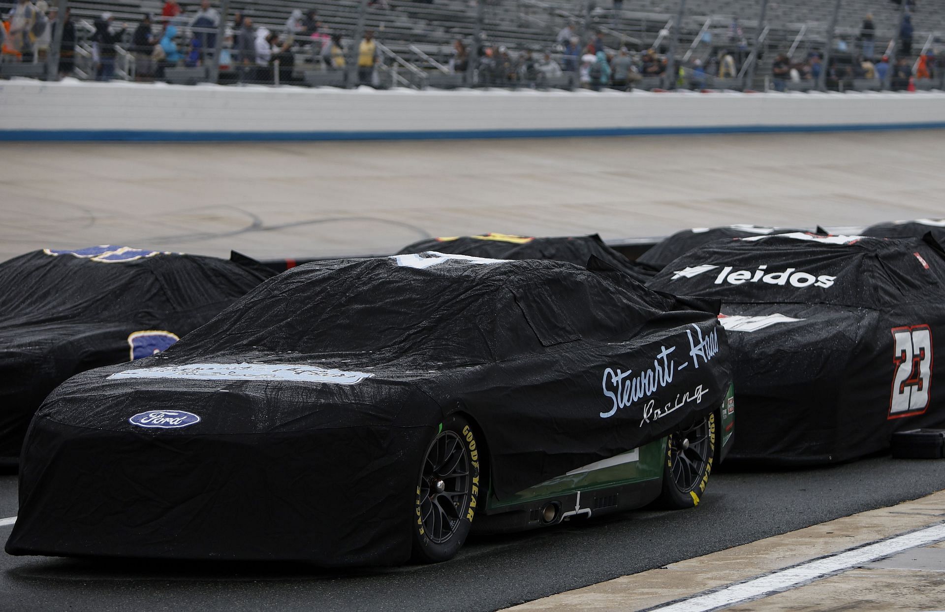 Cars sit covered on the grid during a rain delay in the NASCAR Cup Series DuraMAX Drydene 400 presented by RelaDyne at Dover Motor Speedway (Photo by Sean Gardner/Getty Images)
