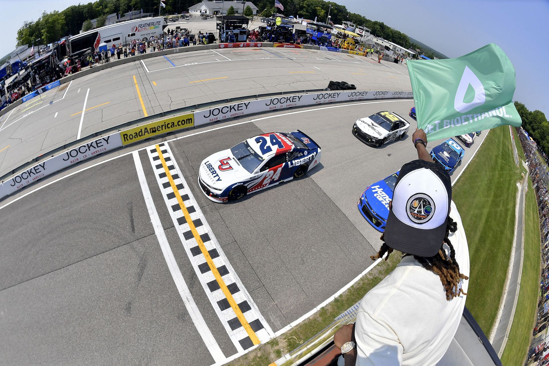 William Byron leads the field to the green flag waved by running back Aaron Jones of the Green Bay Packers to start the 2021 NASCAR Cup Series Jockey Made in America 250 Presented by Kwik Trip at Road America in Elkhart Lake, Wisconsin (Photo by Logan Riely/Getty Images)