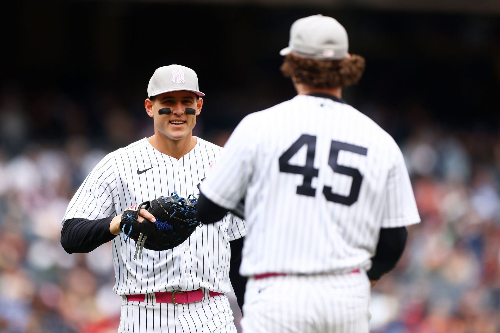 Anthony Rizzo returns the ball to Gerrit Cole during a New York Yankees v Texas Rangers game.