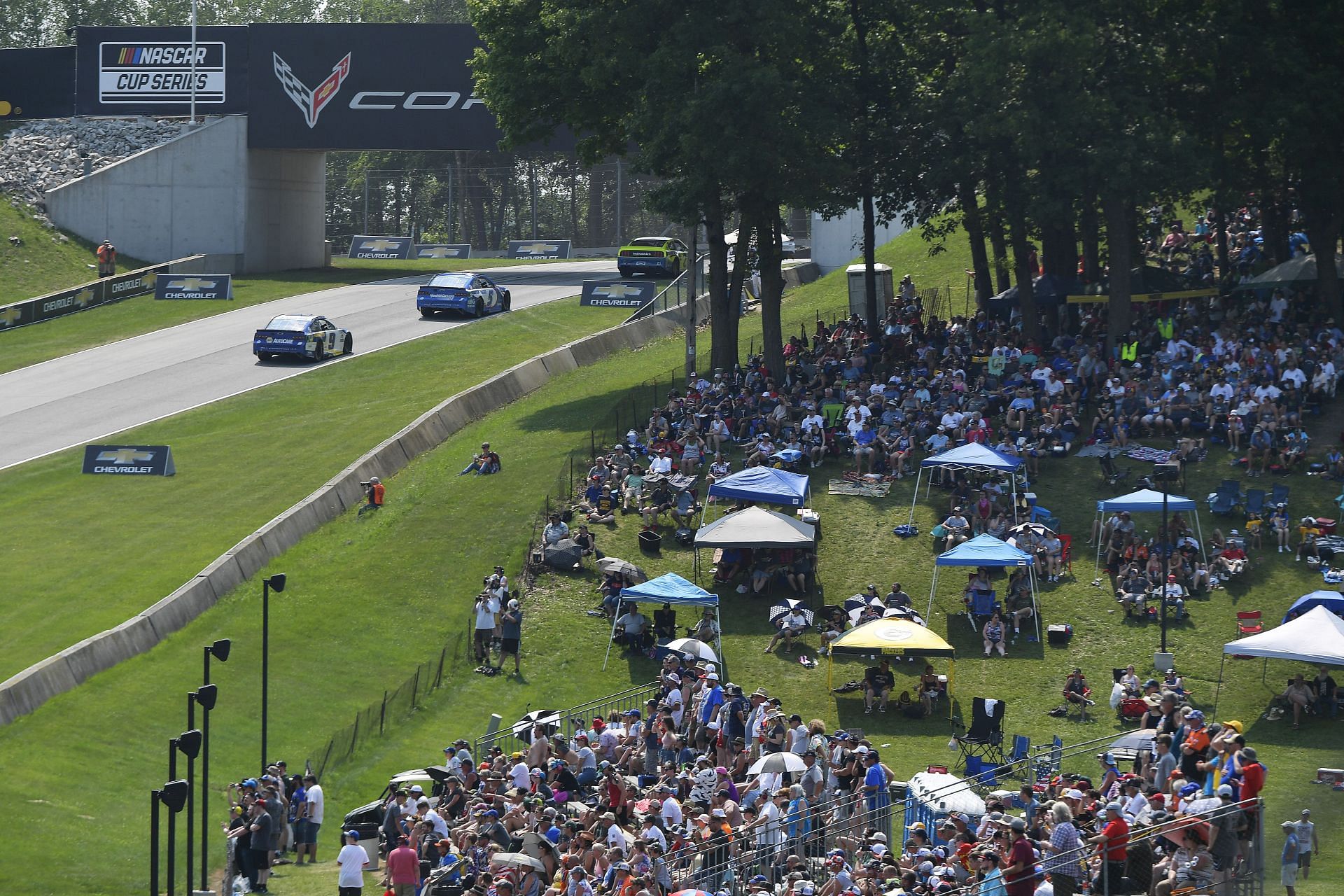 A general view of NASCAR fans on a grassy field and under canopies watching the NASCAR Cup Series Jockey Made in America 250 Presented by Kwik Trip at Road America (Photo by Logan Riely/Getty Images)