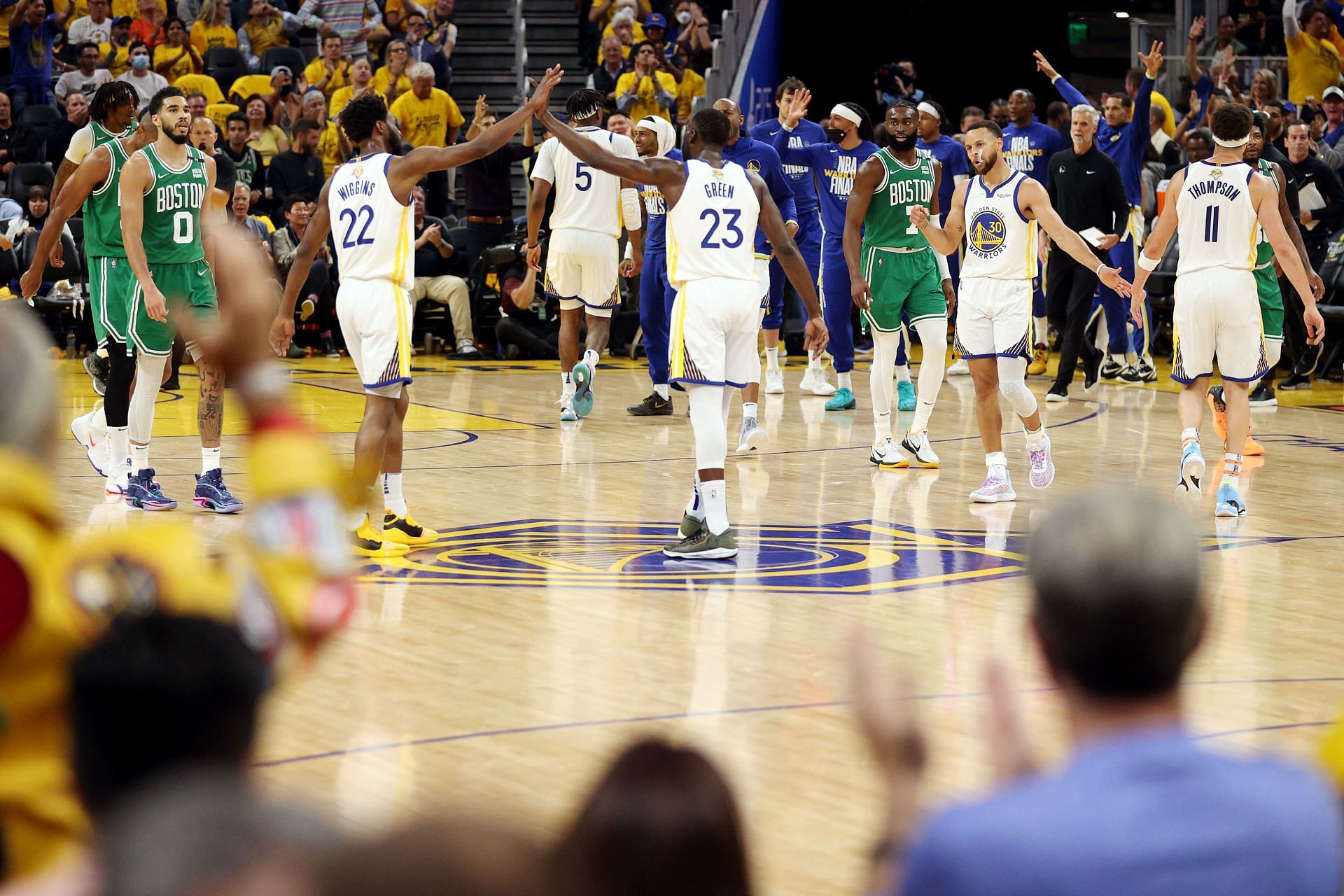 Draymond Green and Andrew Wiggins of the Golden State Warriors react.