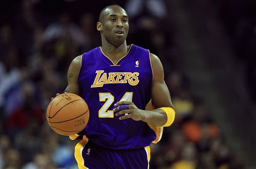 Kobe Bryant No. 24 of the Los Angeles Lakers dribbles the ball up the court.