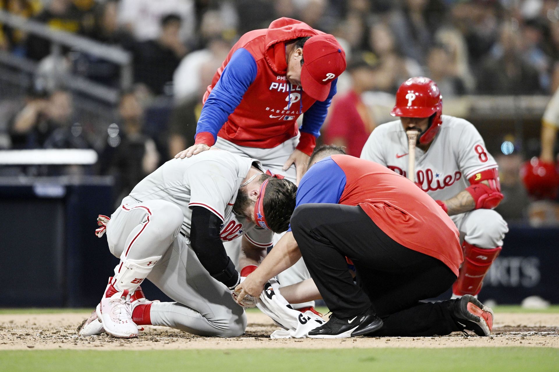 Bryce Harper is looked at after being hit with a pitch during the fourth inning of a baseball game against the San Diego Padres
