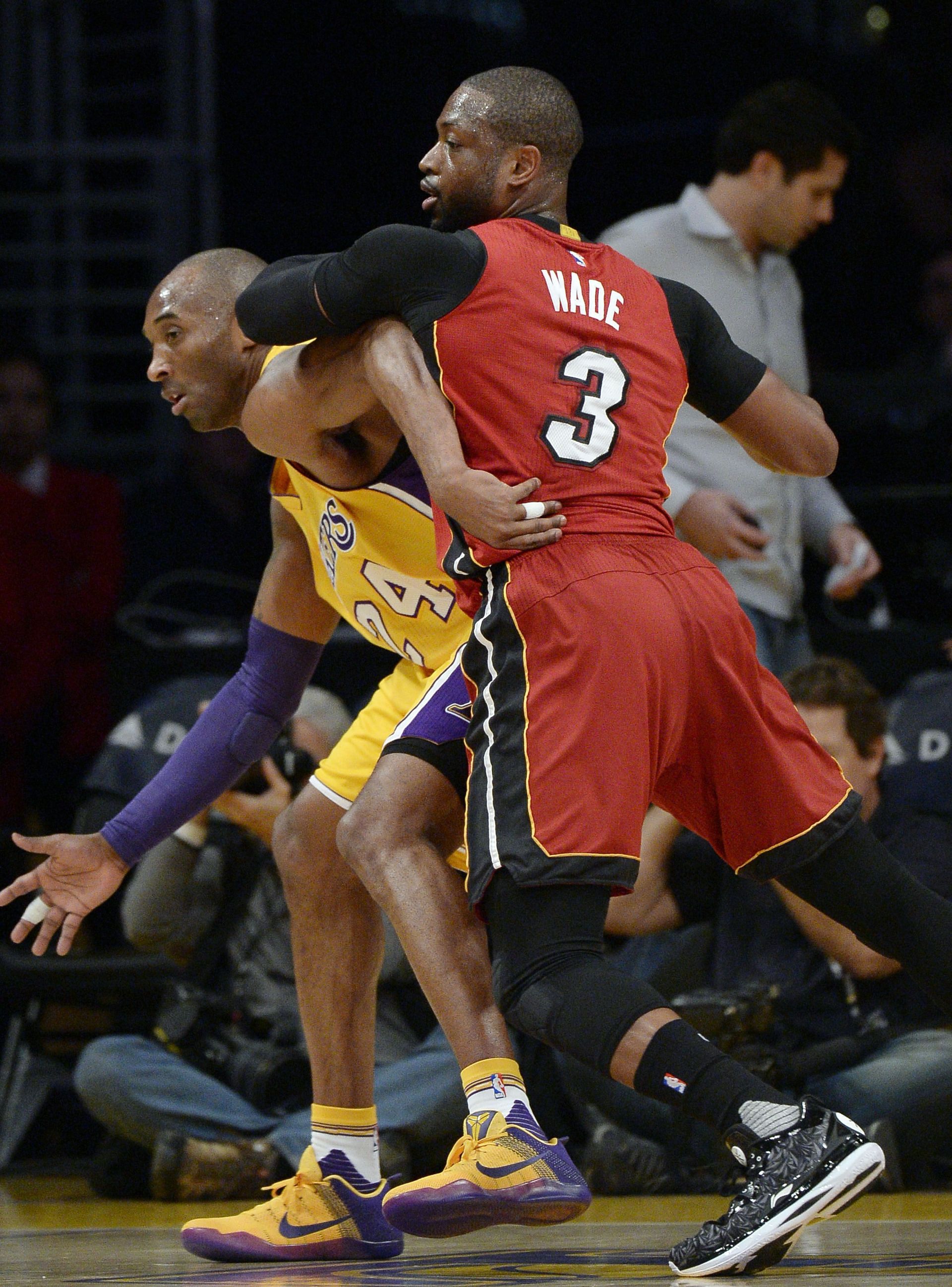 LA Lakers star Kobe Bryant posts up as Miami Heat star Dwyane Wade defends.