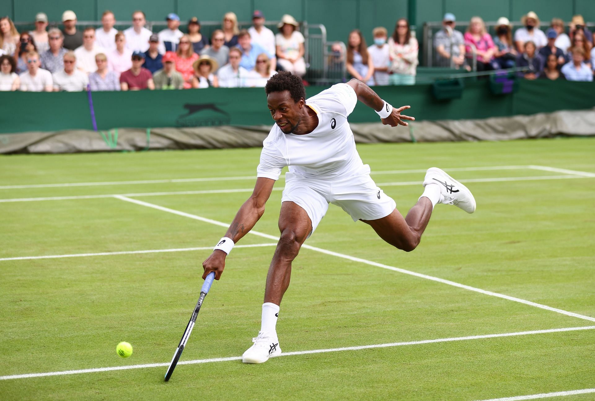 Gael Monfils attempts to reach a ball at Wimbledon