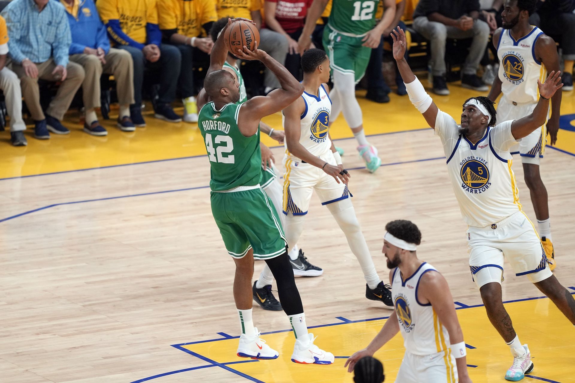 Al Horford shoots over Kevon Looney during 2022 NBA Finals - Game One
