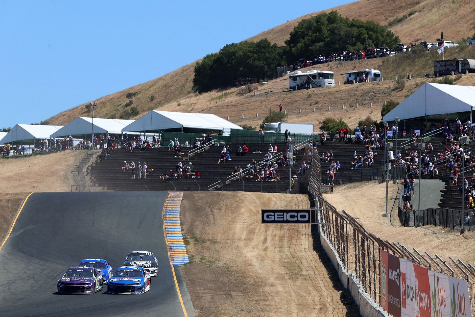 Cars race past grandstands during the NASCAR Cup Series Toyota/Save Mart 350 at Sonoma Raceway (Photo by Carmen Mandato/Getty Images)