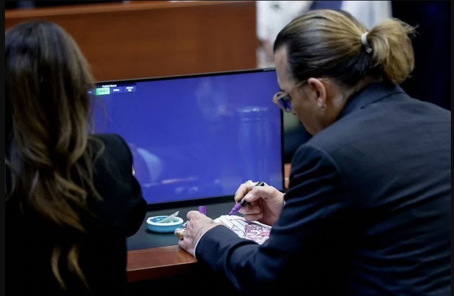 Johnny Depp seen doodling in the courtroom (Image via Twitter)