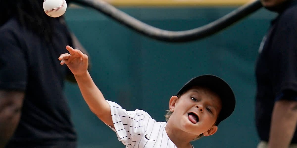 Young Chicago White Sox fan Beau Dowling throws out the ceremonial first pitch. (Image from Nam Y. Huh of the AP)