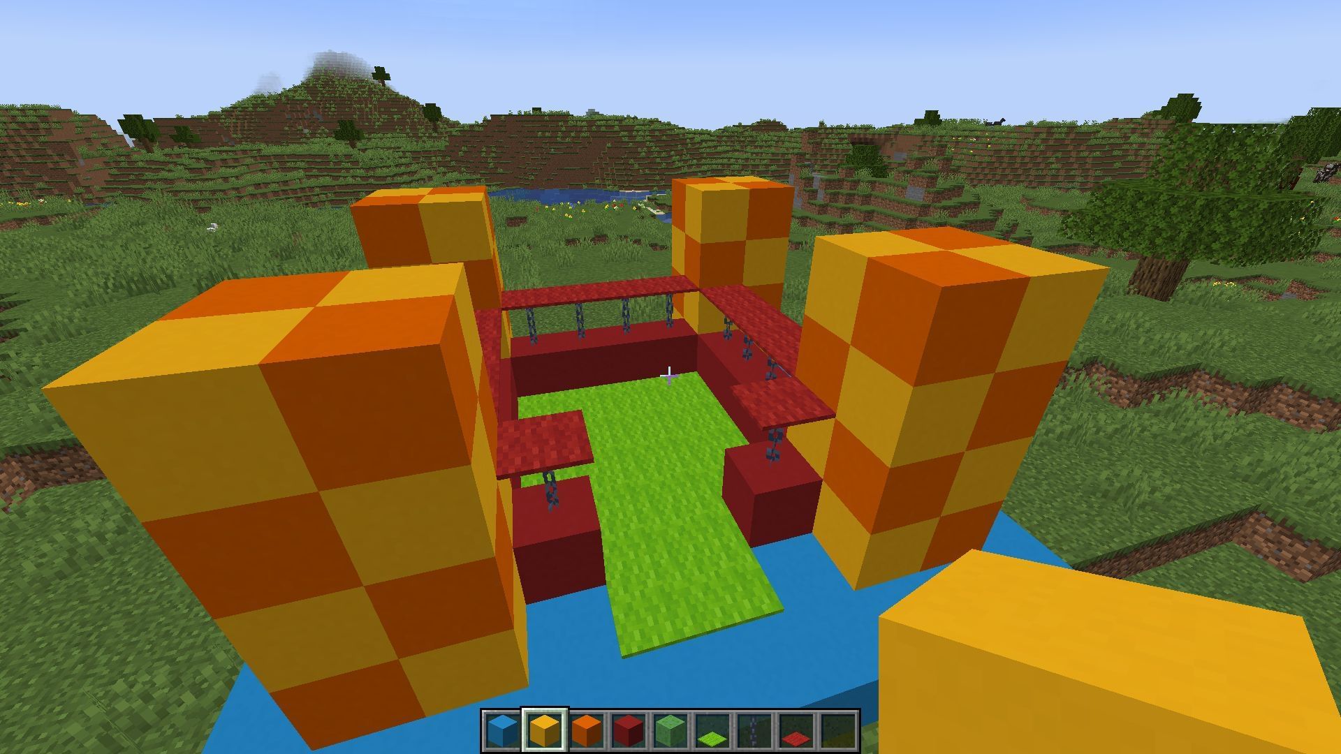 The chains, carpets, and checkboard pillars were added to the bouncy house (Image via Minecraft)