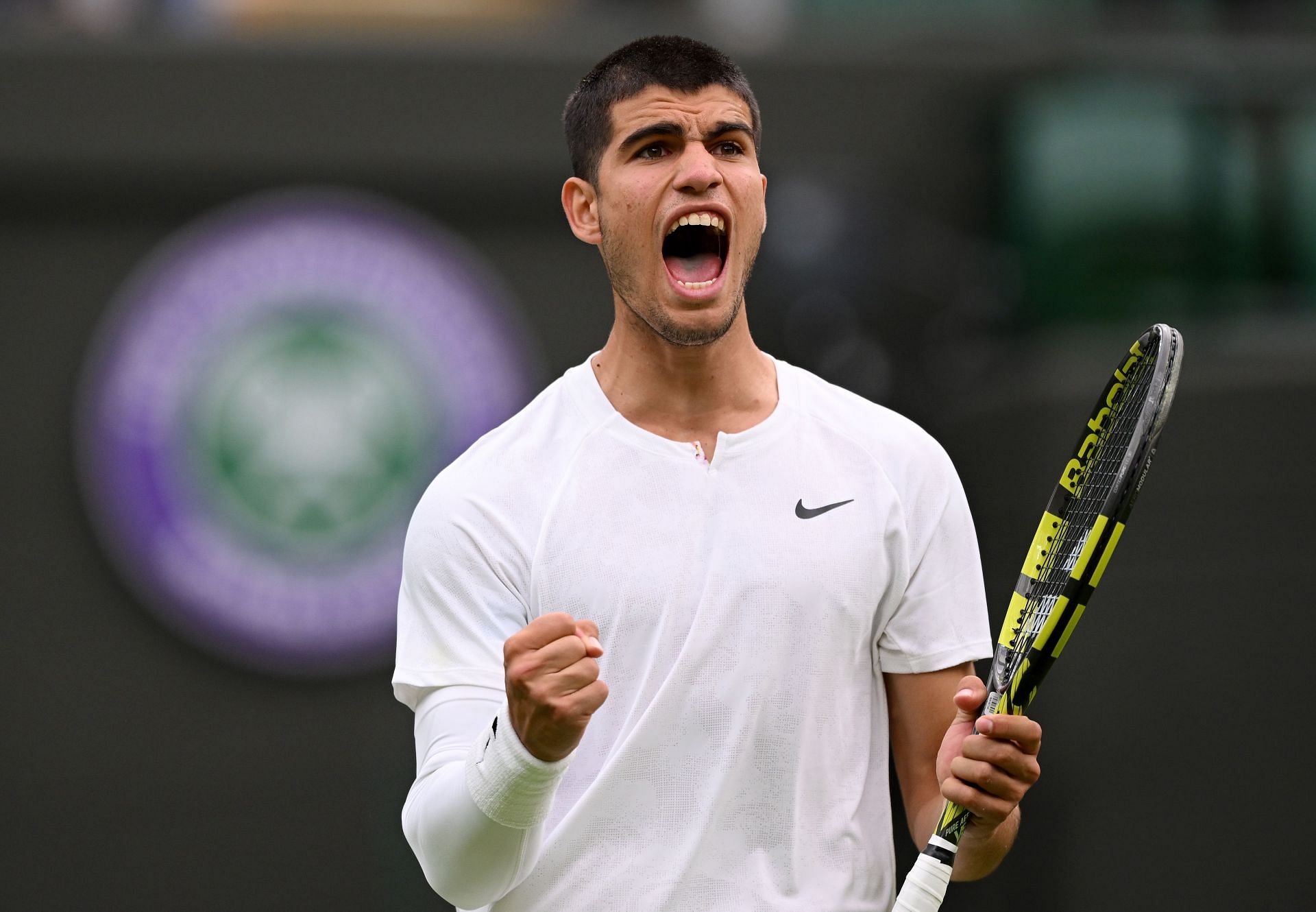 Carlos Alcaraz is through to the second round at Wimbledon.