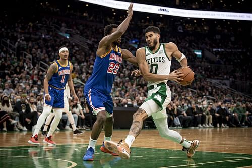 Andrew Wiggins attempts to stop Jayson Tatum