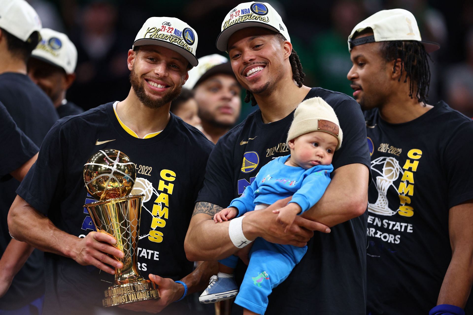 Steph Curry, left, and Damion Lee of the Golden State Warriors after winning the 2022 NBA title