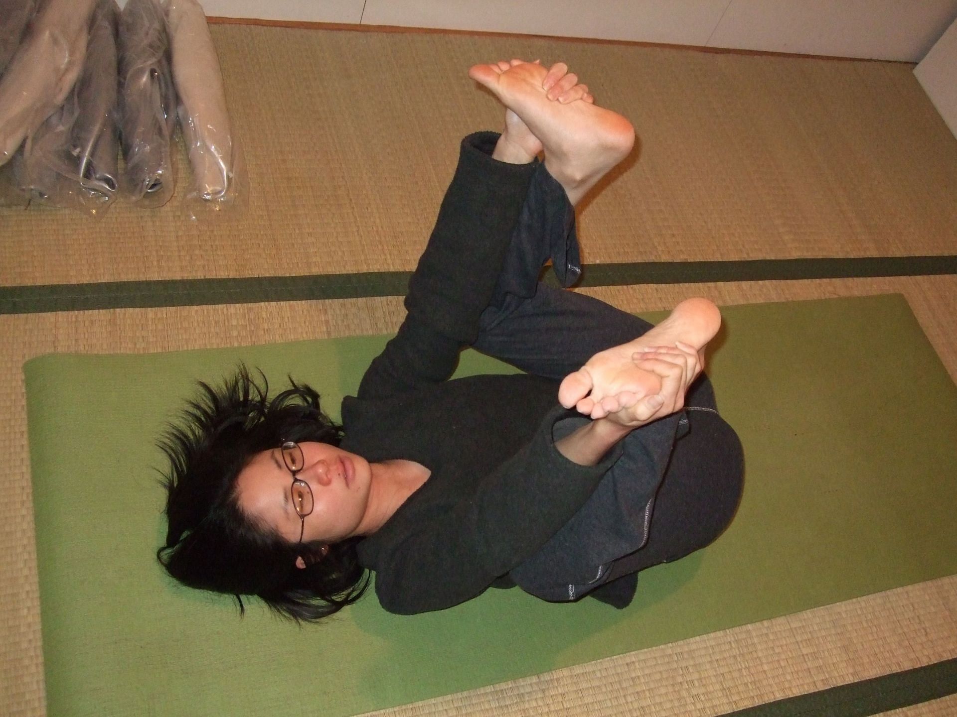 Ananda Balasana is a beginner-level pose that is common in Yoga and Pilates (Image via Flickr @misha jade kiyomura)