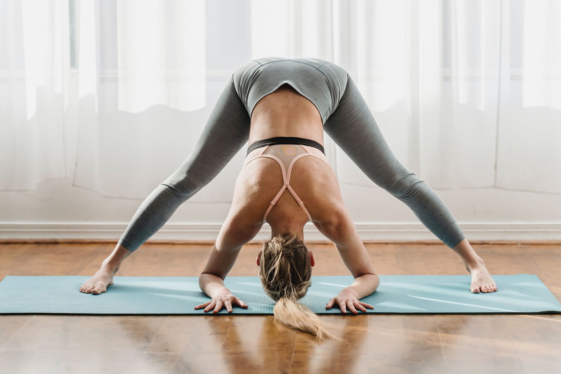 The Prasarita Padottanasana deeply stretches your legs, back and arms (Image via Pexels @Marta Wave)