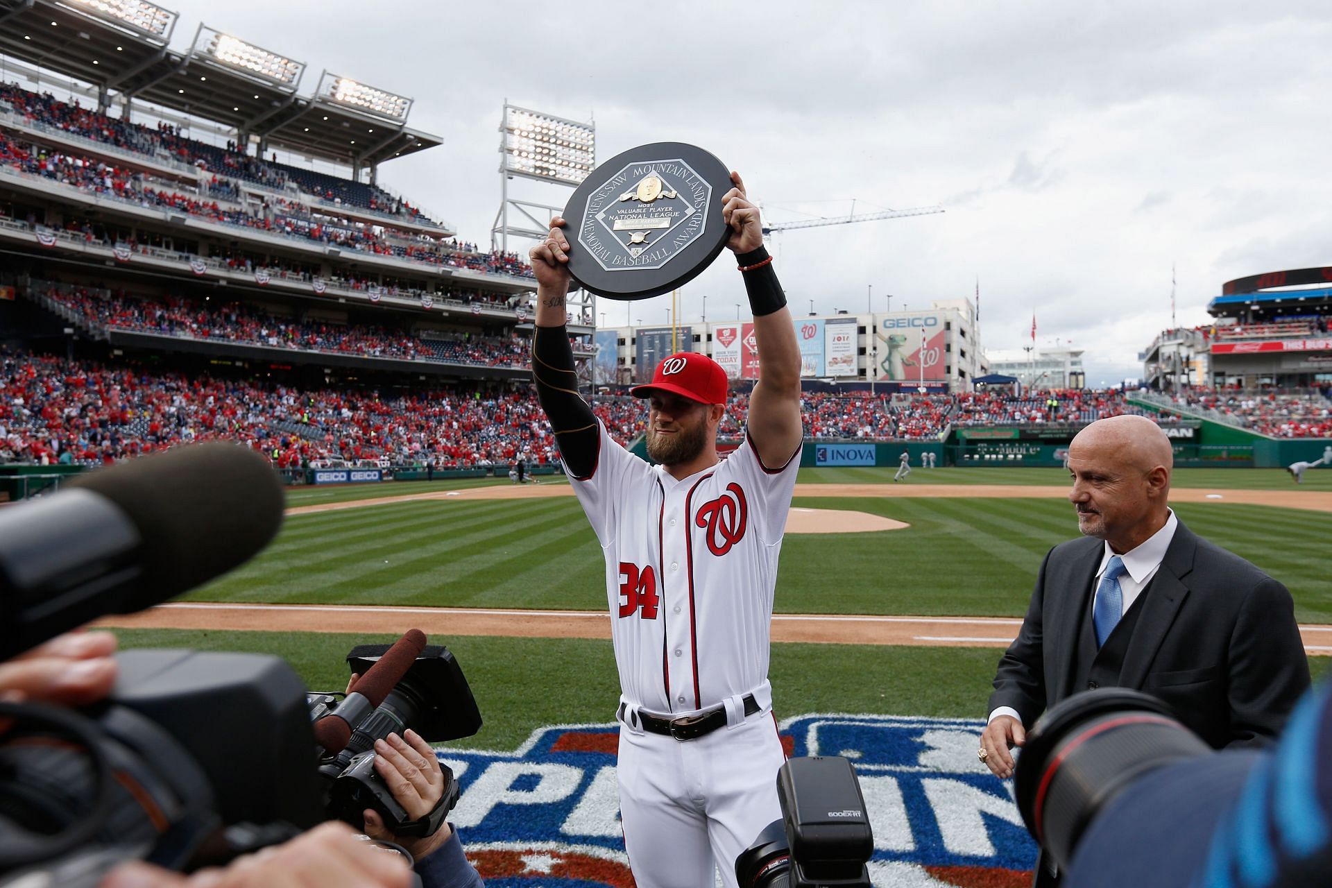 Bryce Harper of the Washington Nationals holds up the 2015 MVP trophy.