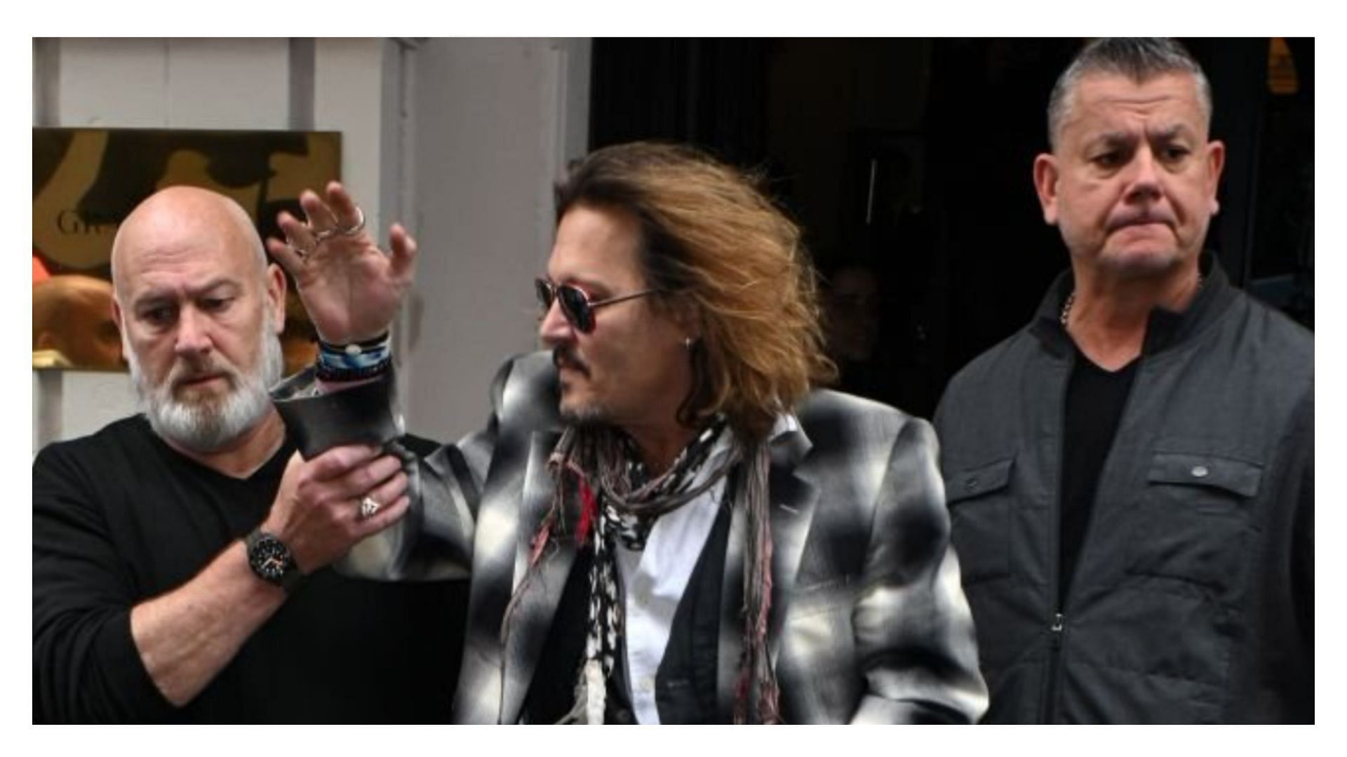 Johnny Depp being accompanied by his security team (Image via MEGA/Getty Images)