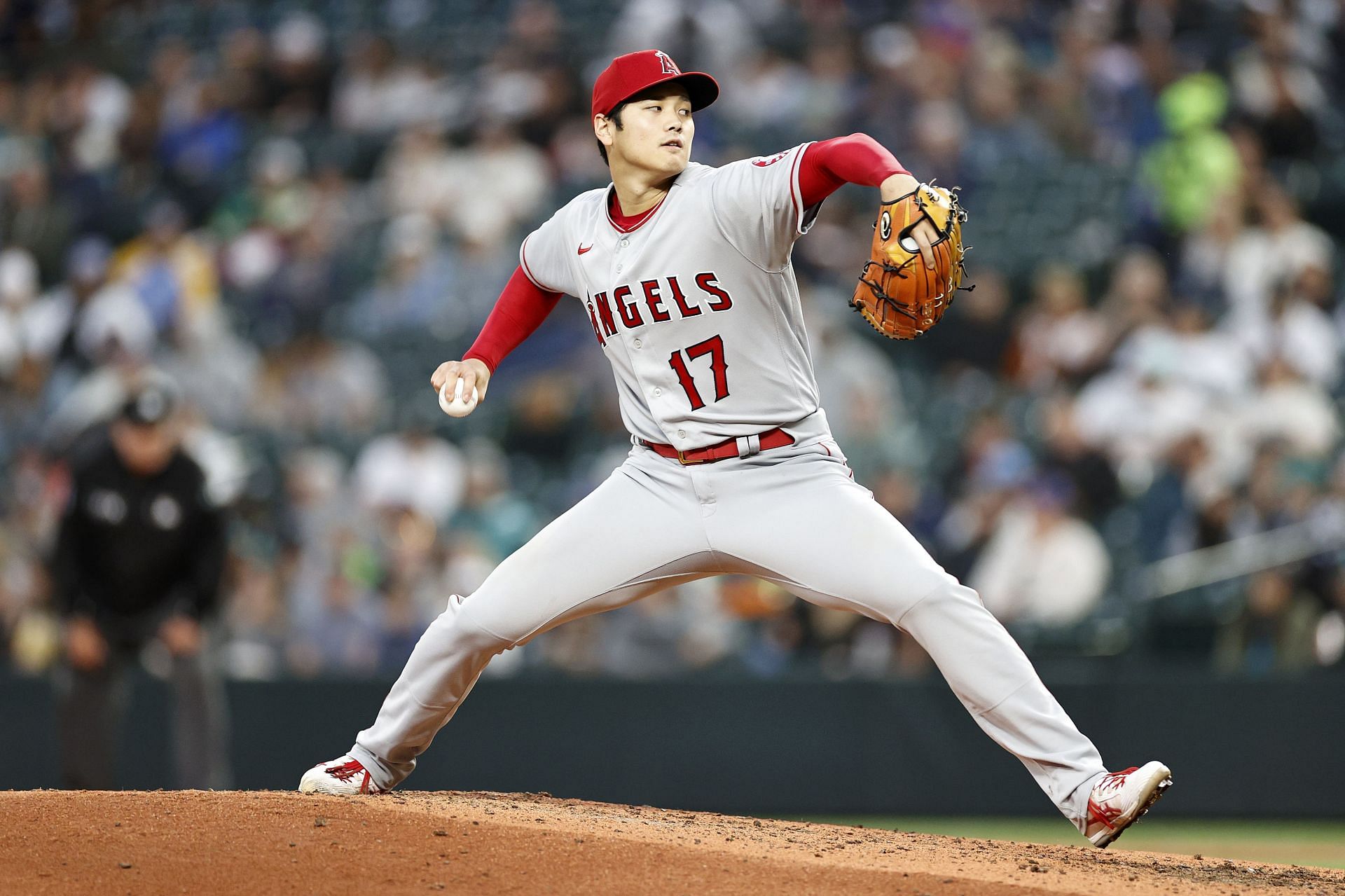 Shohei Ohtani (R) of the Los Angeles Angels hands his protective