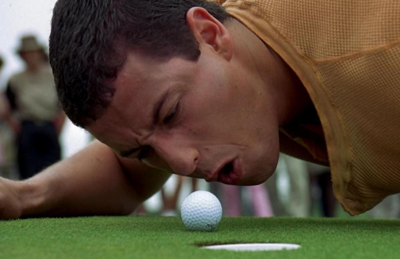 Happy Gilmore abuses a golf ball after it doesn&#039;t go into the hole (Image via Universal Pictures)